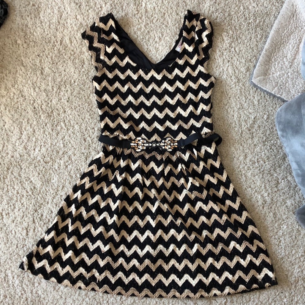 Candie’s black and gold dress with stretchy belt
